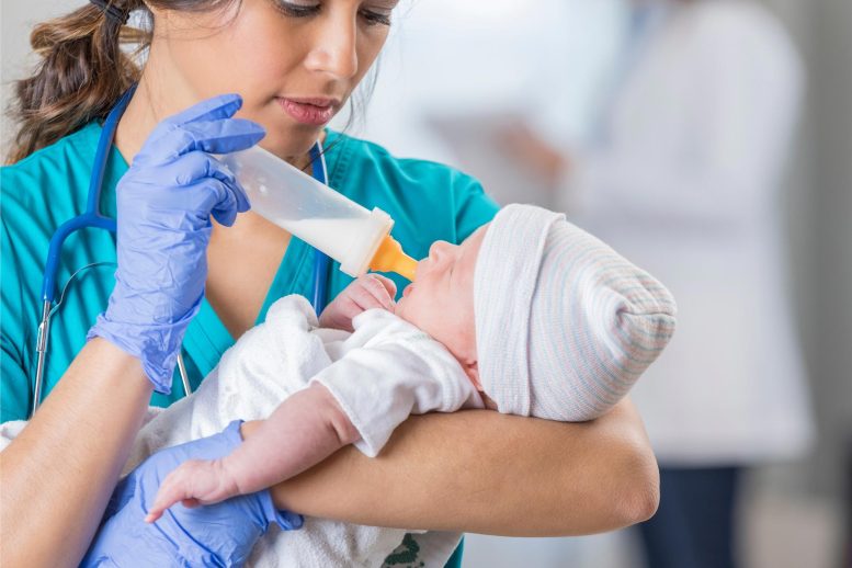 Nurse Feeding Newborn Baby in Hospital