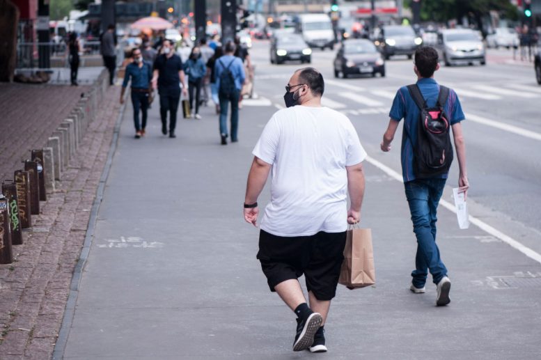 Overweight Pedestrian Walking on City Street