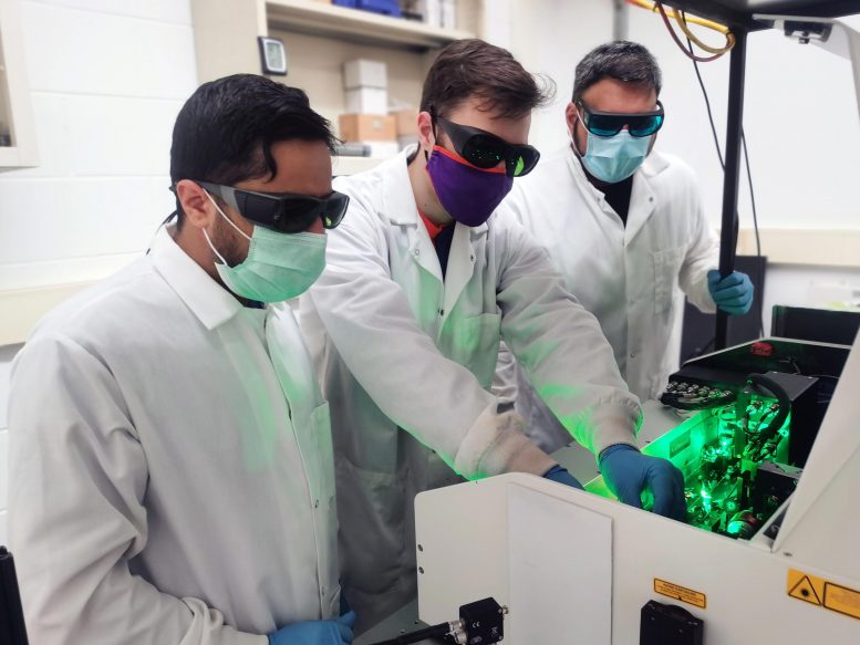 From left, Pan Adhikari, Lawrence Coleman and Kanishka Kobbekaduwa align the ultrafast laser in the Department of Physics and Astronomy's UPQD lab. Credit Clemson University