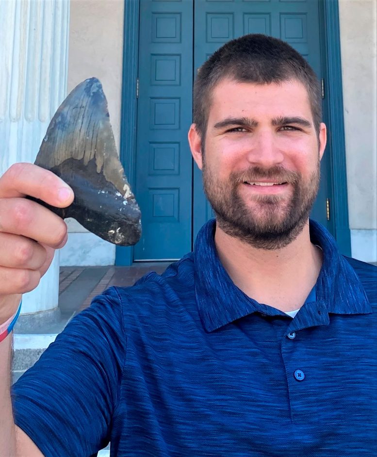 Phillip Sternes Holding Megalodon Tooth