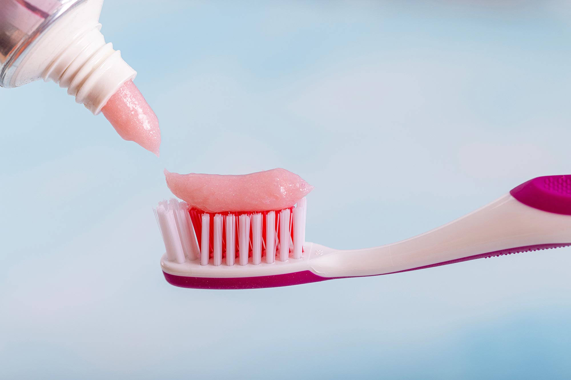 Toothpaste and toothbrush with pink toothpaste