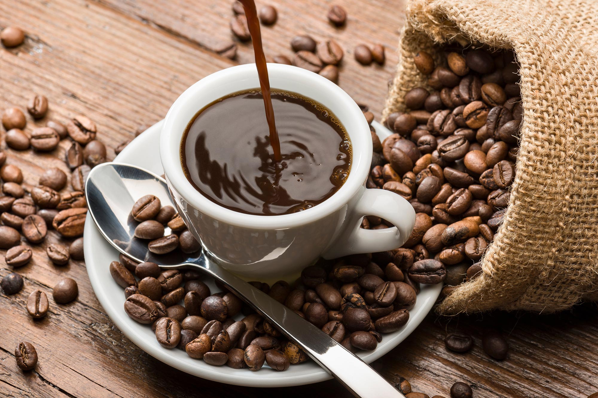https://scitechdaily.com/images/Pouring-Espresso-Coffee-Beans.jpg