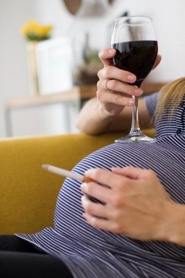 Pregnant Woman Smoking Cigarette Drinking Wine