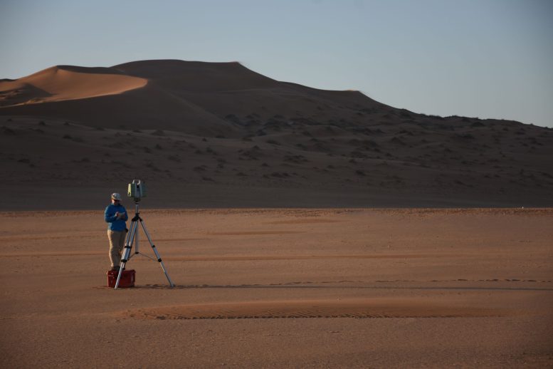 Professor Jo Neild Standing Behind a Patch of Mini Dunes in Namibia