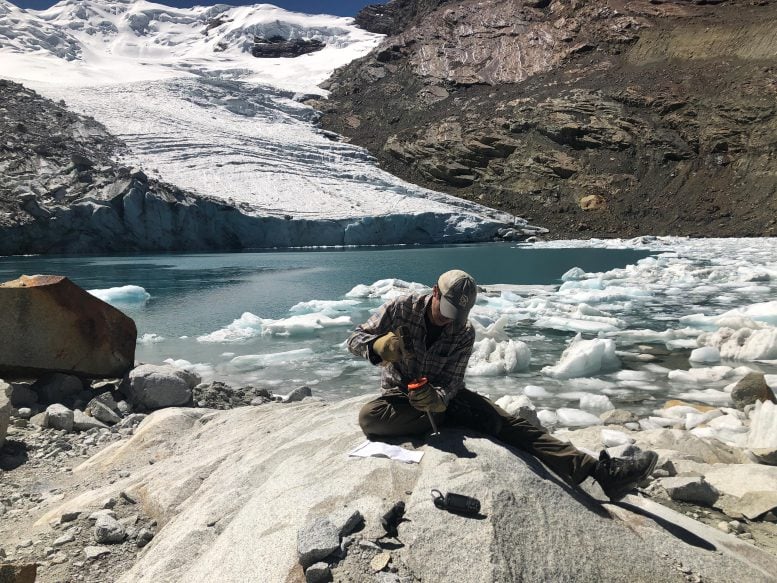 Researcher Collects a Sample of Bedrock From the Queshque Glacier