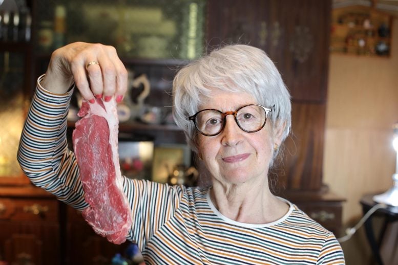 Senior Woman Holding Raw Beef Steak