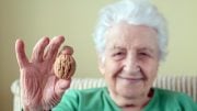 Senior Woman Holding Walnut