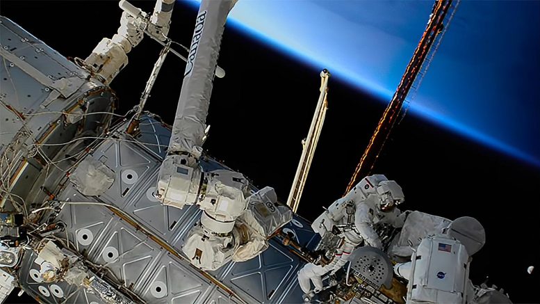 Spacewalkers Work Orbital Sunrise