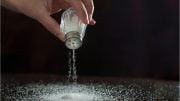Sprinkling Salt on Table Concept