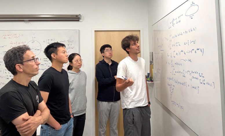 Stephen Naus Explains a Theory on a Whiteboard