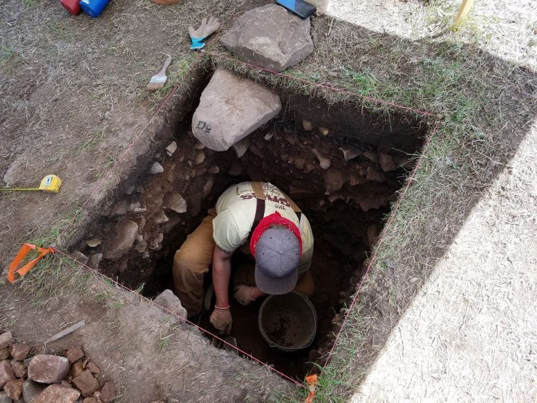 Students Conducting Archaeological Excavations Inside a Hole