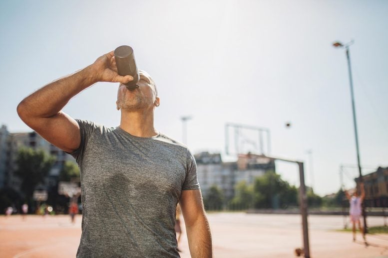 Sweaty Sports Man Drinking Water