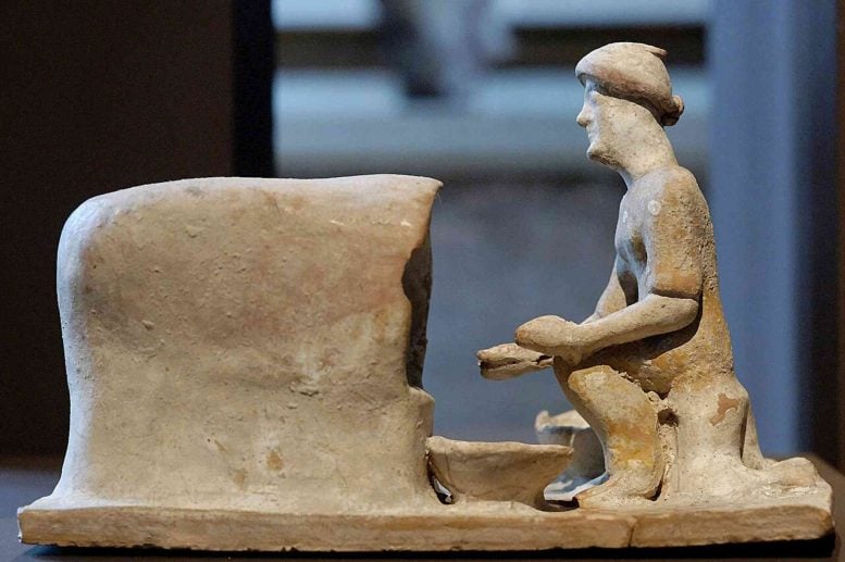 Terracotta Depiction of a Baker Sitting in Front of an Oven