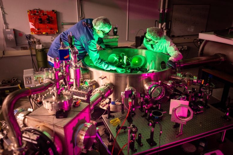 UoM Researchers Inspecting ZEUS Laser Equipment in Laboratory