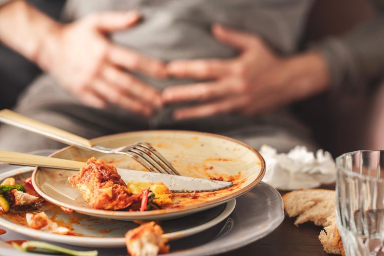 Woman Bloating Stomach Pain After Large Dinner Meal