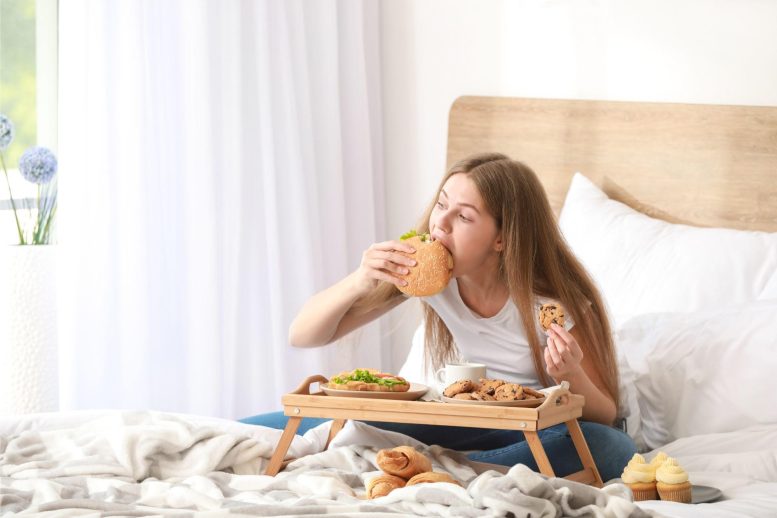 Woman Eating Junk Food in Bed
