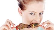 Woman Eating Meat Skewer