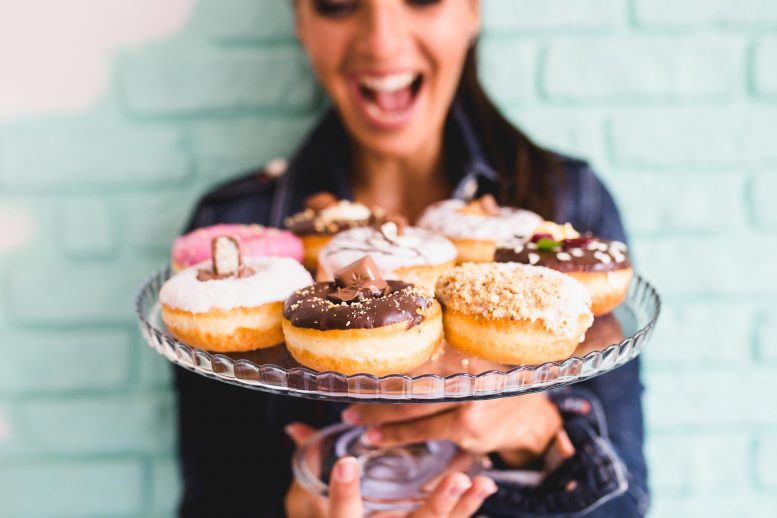 Woman Holding Donuts