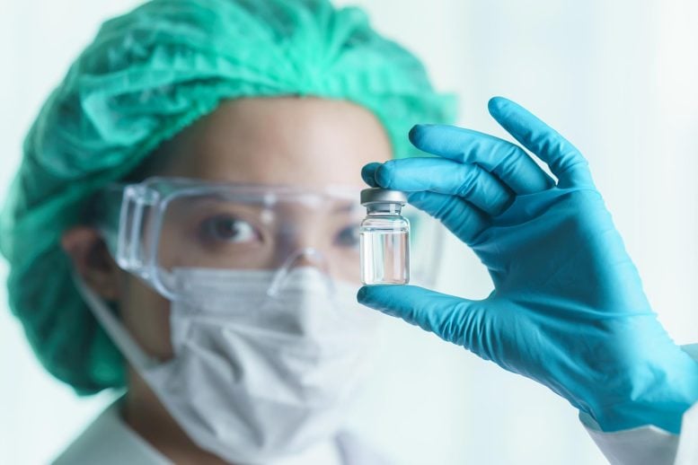 Woman Scientist Holding Vaccine Vial