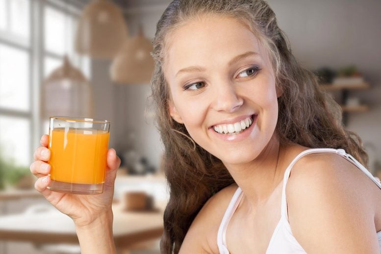 Young Happy Woman Drinking Orange Juice