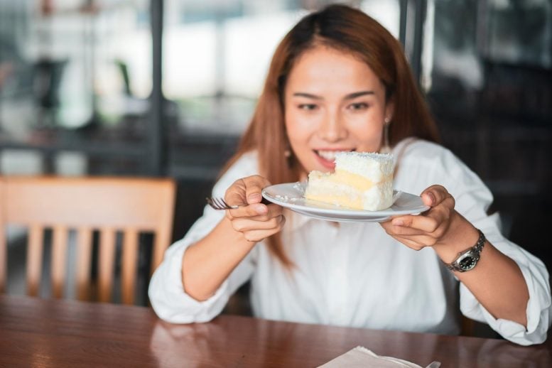 Young Woman Eating Cake