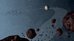 asteroids that lap the sun in the same orbit as Jupiter are uniformly dark with a hint of burgundy color