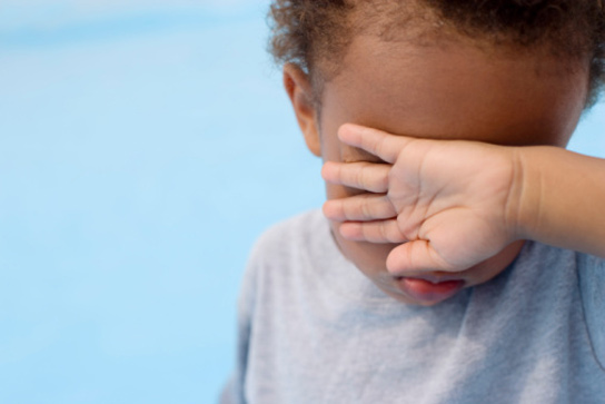 Toddlers love to play hide and seek because they believe they are invisible  behind hands