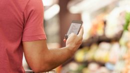 Close Up Of Man Reading Shopping List From Mobile Phone In Supermarket iStockphoto.com