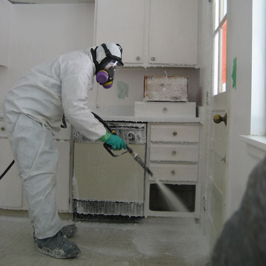 remediator sprays Crystal Clean on surfaces of a house contaminated with methamphetamine