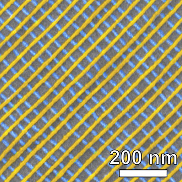 Scanning electron microscope image of a self-assembled platinum lattice, false-colored to show the two-layer structure. Each inner square of the nanoscale grid is just 34 nanometers on each side.