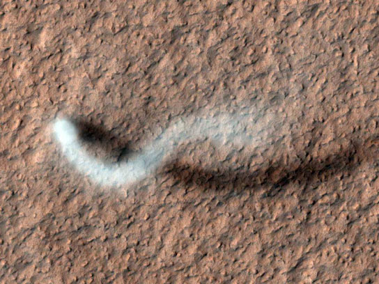 towering dust devil casts a serpentine shadow over the Martian surface